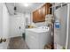 Practical laundry room includes a washer, dryer, utility sink, and overhead storage for convenience at 4501 N Wheeling Ave # 6A - 201, Muncie, IN 47304