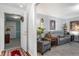 Comfortable living room with grey reclining sofa, armchair, and view into the foyer at 4501 N Wheeling Ave # 6A - 201, Muncie, IN 47304