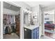 Chic bathroom featuring marble countertops, a walk-in closet, modern fixtures, and access to the main bedroom at 481 Autumn Springs Ct, Avon, IN 46123