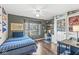 Cozy bedroom with dark gray walls, ceiling fan, wood floors, and a large window with a view of the neighborhood at 481 Autumn Springs Ct, Avon, IN 46123