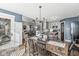 Open concept dining room featuring hardwood floors, lots of natural light, modern chandelier, and open to kitchen at 481 Autumn Springs Ct, Avon, IN 46123