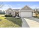 Inviting exterior featuring a two-car garage, manicured lawn, and a combination of brick and siding at 481 Autumn Springs Ct, Avon, IN 46123