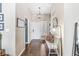 Entrance featuring wood flooring, a stylish light fixture, and view to a white front door and sitting bench at 481 Autumn Springs Ct, Avon, IN 46123