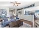 Inviting living room with hardwood floors, a large sofa, and an open layout leading to the kitchen at 481 Autumn Springs Ct, Avon, IN 46123