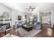 Inviting living room featuring hardwood floors, fireplace, neutral walls, ceiling fan and comfortable seating at 481 Autumn Springs Ct, Avon, IN 46123