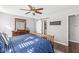 Comfortable main bedroom with wood floors, ceiling fan, large dresser with mirror and sliding door to the closet at 481 Autumn Springs Ct, Avon, IN 46123