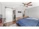 Inviting main bedroom with wood floors, ceiling fan, large dresser with mirror, with access to bathroom via sliding door at 481 Autumn Springs Ct, Avon, IN 46123