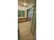 Bathroom with double vanity, glass block wall, shower with glass door and tiled floor at 4969 Fairway Dr, Avon, IN 46123