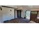 Enclosed sunroom featuring a sliding glass door to the outside deck and indoor/outdoor carpet at 4969 Fairway Dr, Avon, IN 46123