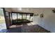 Sunroom with wood paneled walls, indoor/outdoor carpet, and a sliding glass door to the outside deck at 4969 Fairway Dr, Avon, IN 46123