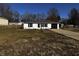 Charming single-story home with a well-manicured front yard and attached garage on a sunny day at 5061 N 200 W, Columbus, IN 47201