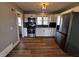 Well-lit kitchen featuring stainless steel appliances, white cabinets, and hardwood floors at 5061 N 200 W, Columbus, IN 47201