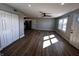 Spacious living room featuring hardwood floors, a ceiling fan, and a large window letting in natural light at 5061 N 200 W, Columbus, IN 47201