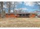 Expansive backyard featuring a brick home with a covered, screened deck at 5108 Chatham Pl, Indianapolis, IN 46226