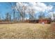 Spacious backyard of the property, featuring the brick home and a fenced boundary at 5108 Chatham Pl, Indianapolis, IN 46226