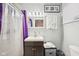 Clean bathroom featuring vanity with storage, bright lighting, and shower with purple accents at 5108 Chatham Pl, Indianapolis, IN 46226