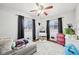 Cozy bedroom with a ceiling fan, two windows, and neutral carpet at 5108 Chatham Pl, Indianapolis, IN 46226