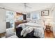 Bedroom featuring plush decor, wood floors, and an en-suite bathroom, perfect for relaxation at 5108 Chatham Pl, Indianapolis, IN 46226