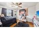Bedroom featuring hardwood floors, window, ceiling fan, and fun decor, perfect for  at 5108 Chatham Pl, Indianapolis, IN 46226