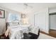 Bright and cozy bedroom featuring a ceiling fan, plush bedding and decor at 5108 Chatham Pl, Indianapolis, IN 46226