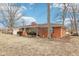 Charming brick home with mature trees, a chimney, and well-manicured landscaping providing curb appeal at 5108 Chatham Pl, Indianapolis, IN 46226