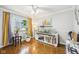 Bright living room featuring polished wood floors and a large window offering natural light at 5108 Chatham Pl, Indianapolis, IN 46226