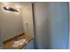Cozy bathroom with a granite countertop vanity, modern faucet, and a classic light fixture at 518 Waterford Way, Danville, IN 46122