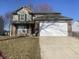 Charming two-story home featuring vinyl siding, brick accents, a two-car garage, and a well-maintained lawn at 518 Waterford Way, Danville, IN 46122