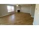 Spacious living room featuring hardwood floors, a ceiling fan, a fireplace, and a large window at 518 Waterford Way, Danville, IN 46122
