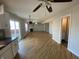 Open concept living space featuring hardwood floors, ample natural light, and seamless flow between kitchen and living areas at 518 Waterford Way, Danville, IN 46122