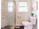 Updated bathroom features a shower with glass door, tiled wall, and modern toilet at 518 Wedgewood Dr, Anderson, IN 46013