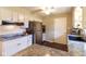 Well-lit kitchen featuring white cabinets, stainless steel appliances, and granite countertops at 518 Wedgewood Dr, Anderson, IN 46013