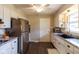 Updated kitchen with white cabinets, granite countertops, stainless steel appliances, and hardwood floors at 518 Wedgewood Dr, Anderson, IN 46013