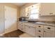 Updated kitchen featuring white cabinets, granite countertops, stainless steel sink, and hardwood floors at 518 Wedgewood Dr, Anderson, IN 46013