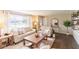 Bright living room featuring hardwood floors, neutral paint, large window, and comfortable seating arrangement at 518 Wedgewood Dr, Anderson, IN 46013