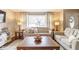 Inviting living room featuring neutral paint, hardwood floors, comfortable seating, and a large window at 518 Wedgewood Dr, Anderson, IN 46013