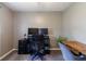 Home office space with modern desk, office chair, and sleek black filing cabinet at 518 Wedgewood Dr, Anderson, IN 46013