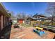 Backyard features a weathered wood deck and a red storage shed, offering functional space at 5414 Honey Comb Ln, Indianapolis, IN 46221