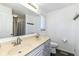 A well-lit bathroom featuring a double sink vanity, toilet, and a full-size mirror at 5414 Honey Comb Ln, Indianapolis, IN 46221