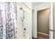 Bathroom featuring a shower-tub combo with a shower curtain, and a small sink area at 5414 Honey Comb Ln, Indianapolis, IN 46221