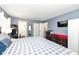 Comfortable bedroom featuring a large bed with an ensuite bathroom, dressers and TV at 5414 Honey Comb Ln, Indianapolis, IN 46221