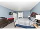 Cozy bedroom featuring a large bed, two dressers, and a TV mounted on the wall at 5414 Honey Comb Ln, Indianapolis, IN 46221