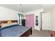 Bedroom with carpet flooring, a large bed, dresser, and a closet with mirrored doors at 5414 Honey Comb Ln, Indianapolis, IN 46221