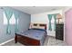 Cozy bedroom featuring a wood-framed bed, gray accent wall, and playful decor for a comfortable and inviting space at 5414 Honey Comb Ln, Indianapolis, IN 46221