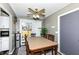 Bright dining area featuring a ceiling fan, wood table and chairs, and access to a rear entrance at 5414 Honey Comb Ln, Indianapolis, IN 46221