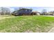 Spacious front yard showcasing a multi-level home with a blend of siding and brick exterior at 5414 Honey Comb Ln, Indianapolis, IN 46221