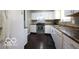 A bright kitchen with white cabinets, sleek countertops, stainless steel appliances and dark flooring at 5414 Honey Comb Ln, Indianapolis, IN 46221