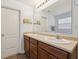 Bathroom featuring a double vanity and tiled floors with lots of natural lighting at 6302 Emerald Field Way, Indianapolis, IN 46221