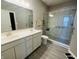 Contemporary bathroom boasting a glass-door shower, double sinks, and modern finishes for a luxurious feel at 6480 E Walton Dr, Camby, IN 46113
