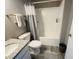 A clean bathroom with a shower and tub combination, a toilet, and a sink with a granite countertop at 6480 E Walton Dr, Camby, IN 46113